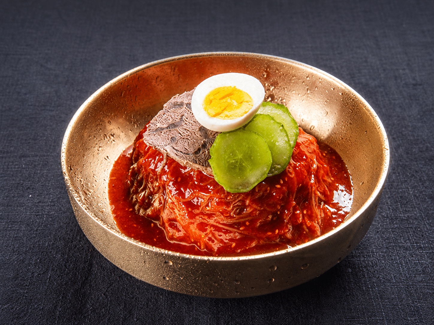 Bibim naengmyeon with spicy sauce, egg, and vegetables